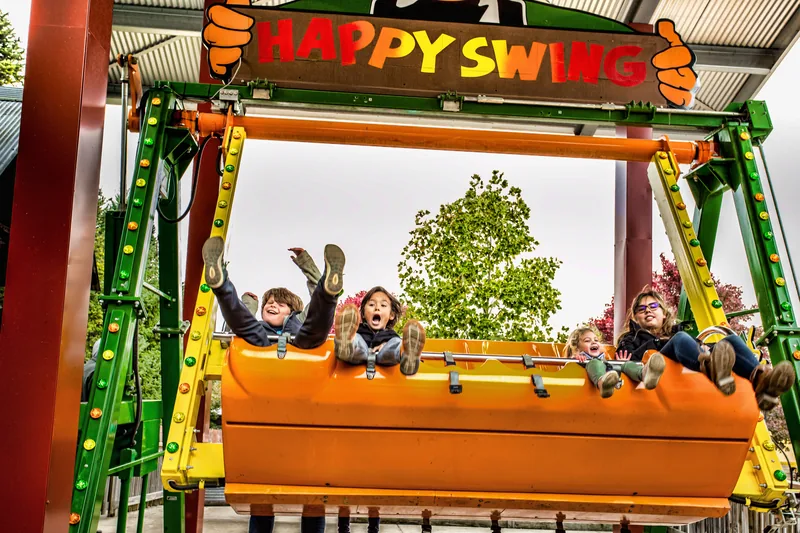 Toddler riding gentle farm swing at pumpkin patch